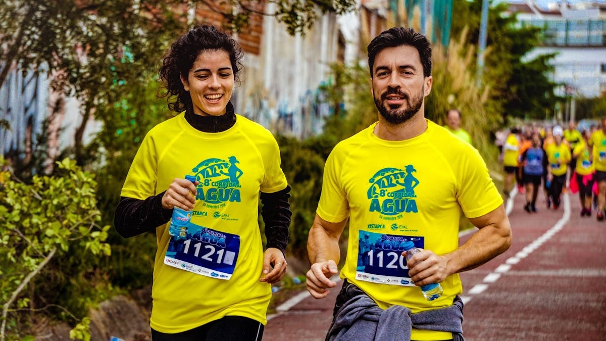 Two athletes participating in a marathon, showing determination and joy.
